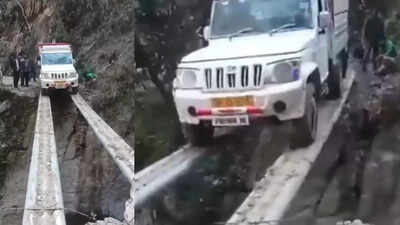 mahindra-bolero-pik-up-balances-on-pipes-to-cross-deep-gap-video-viral.jpg
